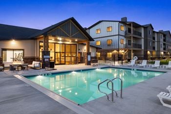 A swimming pool at night in front of a building